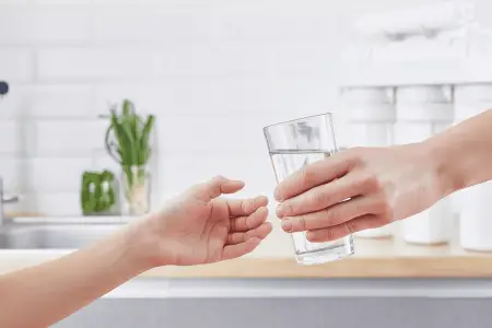 hand giving a purified distilled water